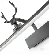 Close view of the black stag head and the dark plate behind the bar