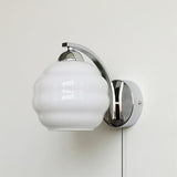 The chrome version with a white ribbed glass globe and its cord