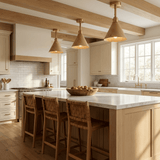 Three cone ceiling lights lit above a kitchen island with wood stools