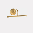 The gold version seen at an angle, the curved arm rising from the round plate