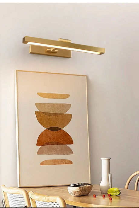 Gold bar over a framed print, dining chairs and a small vase below it
