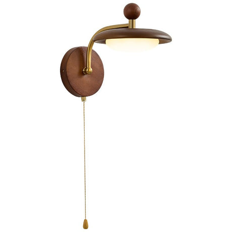 The saucer shade seen from the front on its curved arm and round wood plate