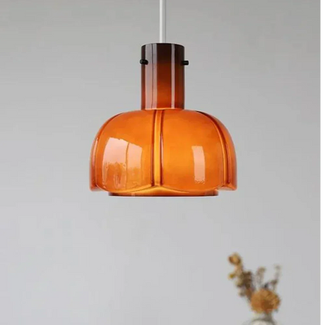 The orange shade shown on its own against a pale wall
