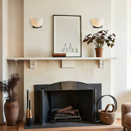 A pair lit above a fireplace beside a shelf with a framed print