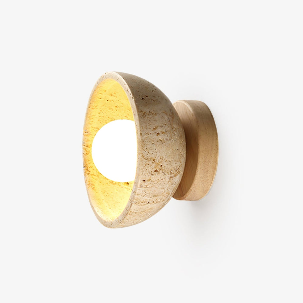 Half moon wall sconce, a travertine bowl on a pale wood disc, lit inside