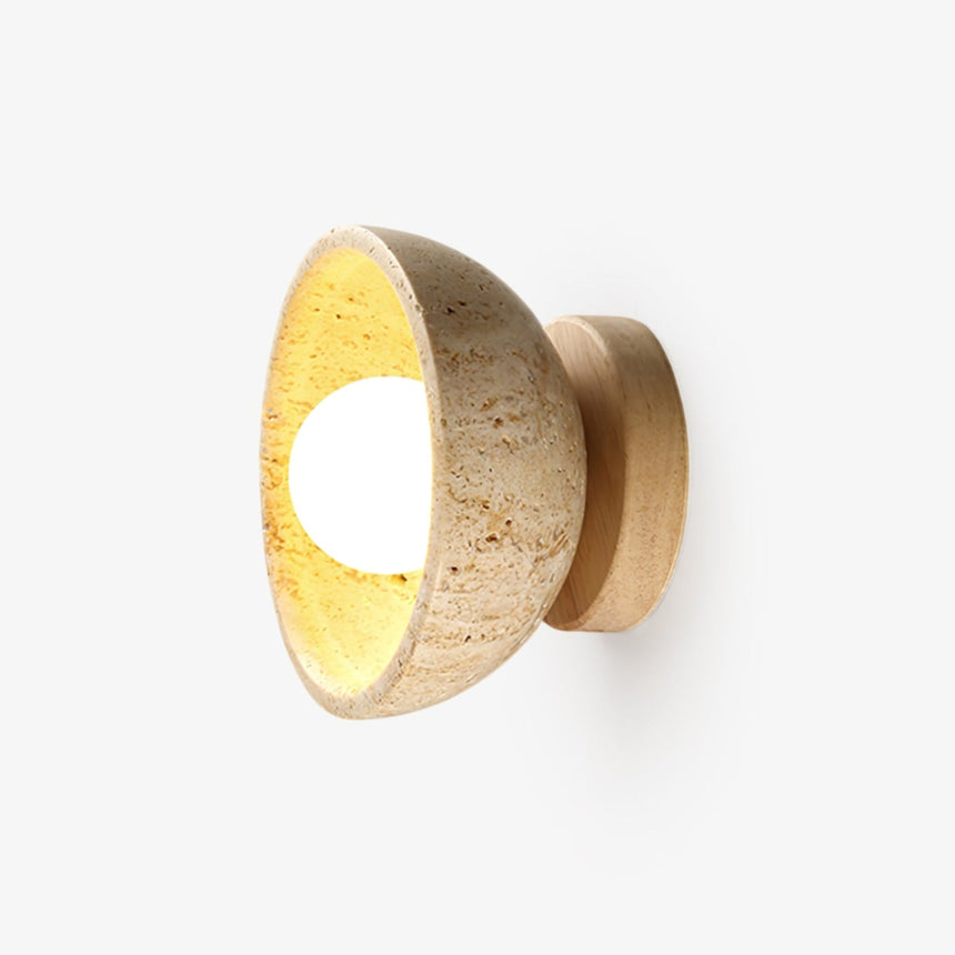 Half moon wall sconce, a travertine bowl on a pale wood disc, lit inside