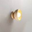 The pale wood version seen from the front, the bowl glowing at its center