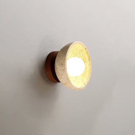 The walnut version seen from the front, the travertine bowl lit inside