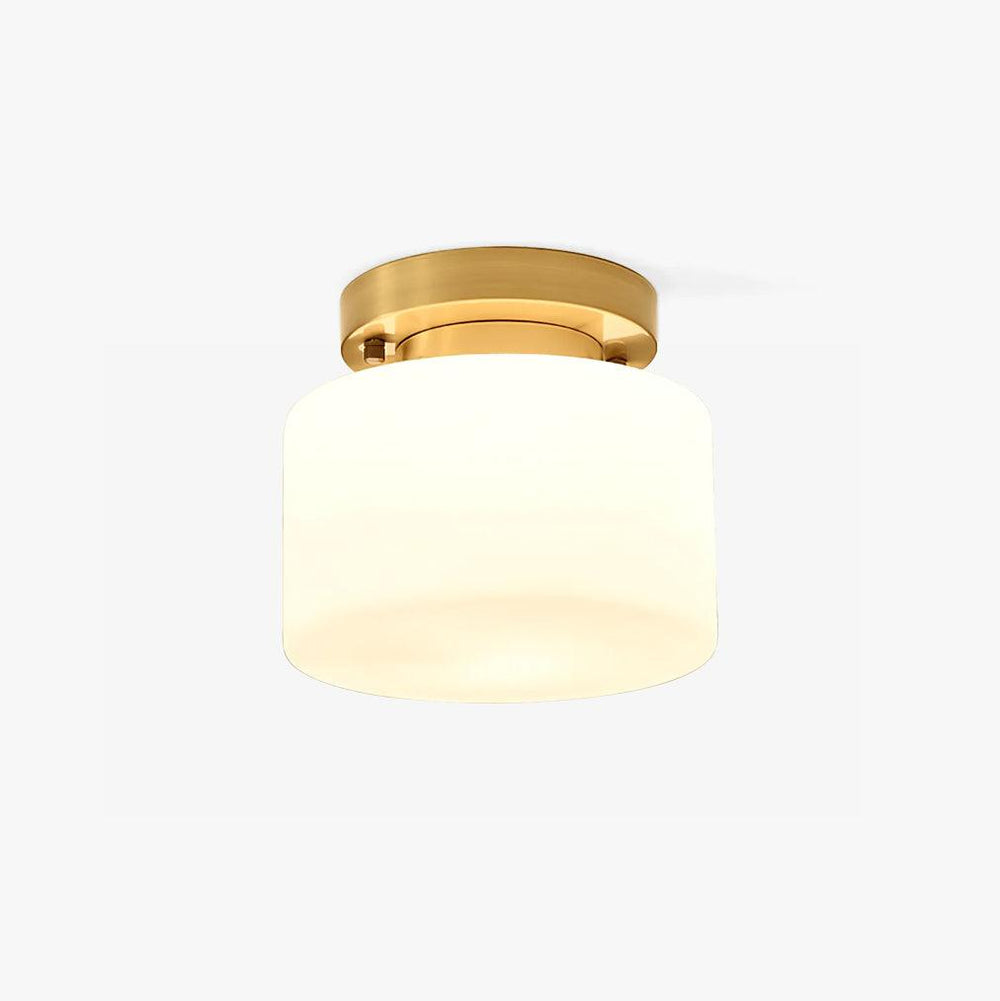 Hallway flush mount ceiling light with a white glass drum and a brass canopy