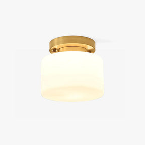 Hallway flush mount ceiling light with a white glass drum and a brass canopy