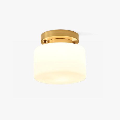 Hallway flush mount ceiling light with a white glass drum and a brass canopy