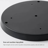 The black cast iron ceiling plate shown face down on a pale background