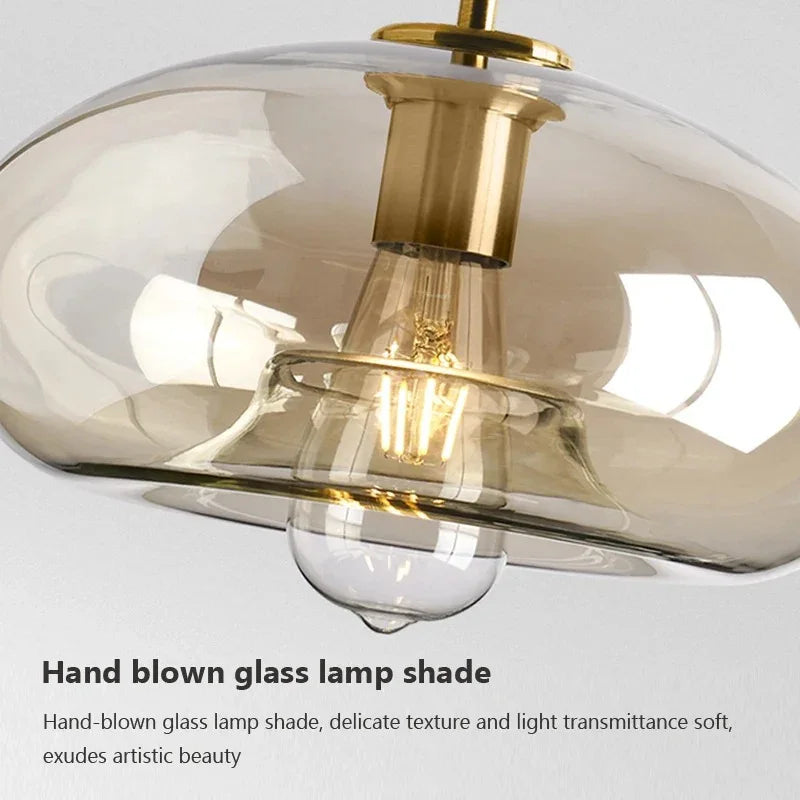 Close view of the amber glass and brass holder with a lit bulb inside