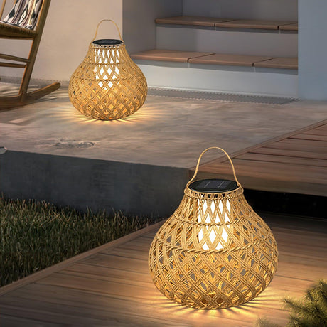 Two lanterns lit on a timber deck beside a doorway and a garden step