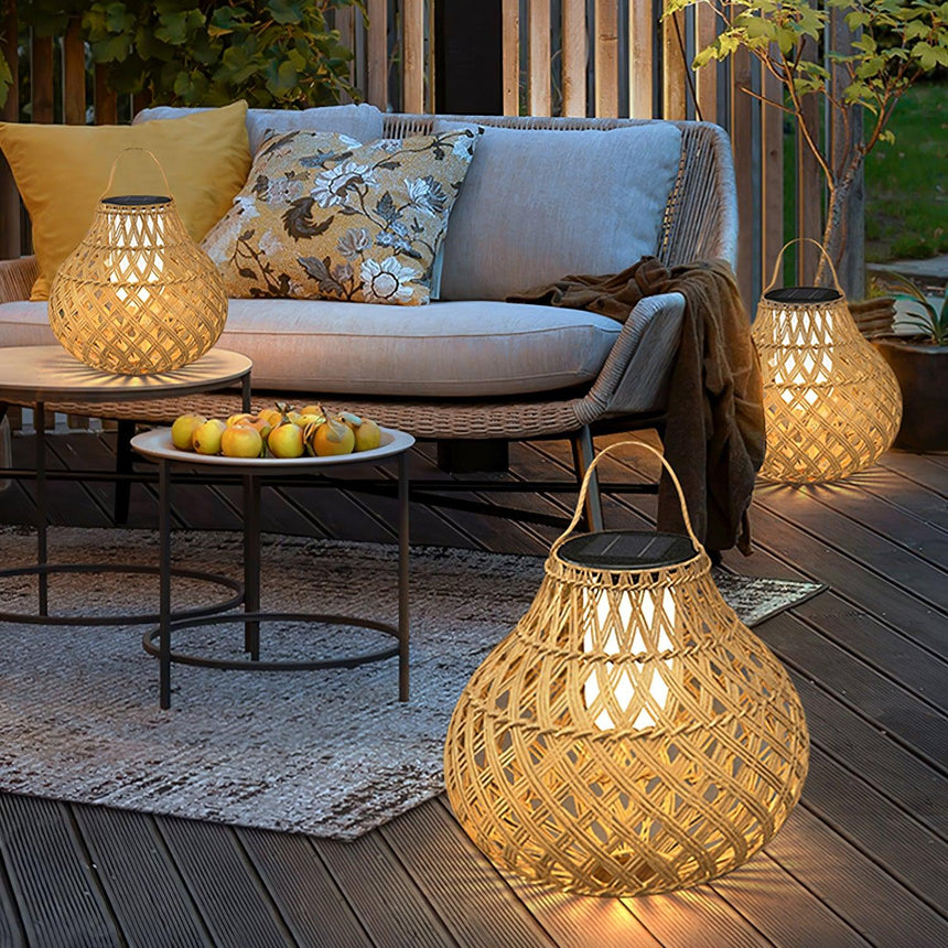 The lantern lit on a timber terrace beside a sofa and a low round table