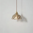 Brass pendant light illuminated above dining table