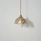Brass pendant light illuminated above dining table