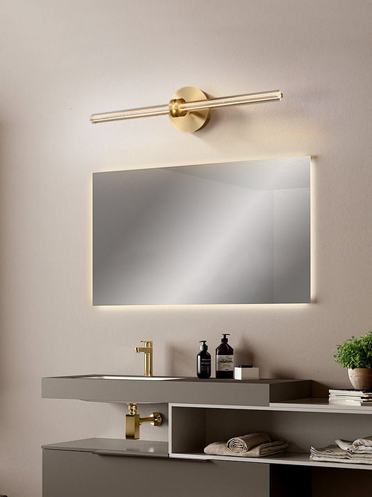 Rod lit above a wide backlit mirror over a stone vanity and a basin