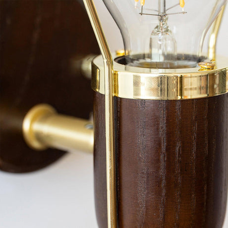Close view of the brass collar joining the wood barrel to its arm