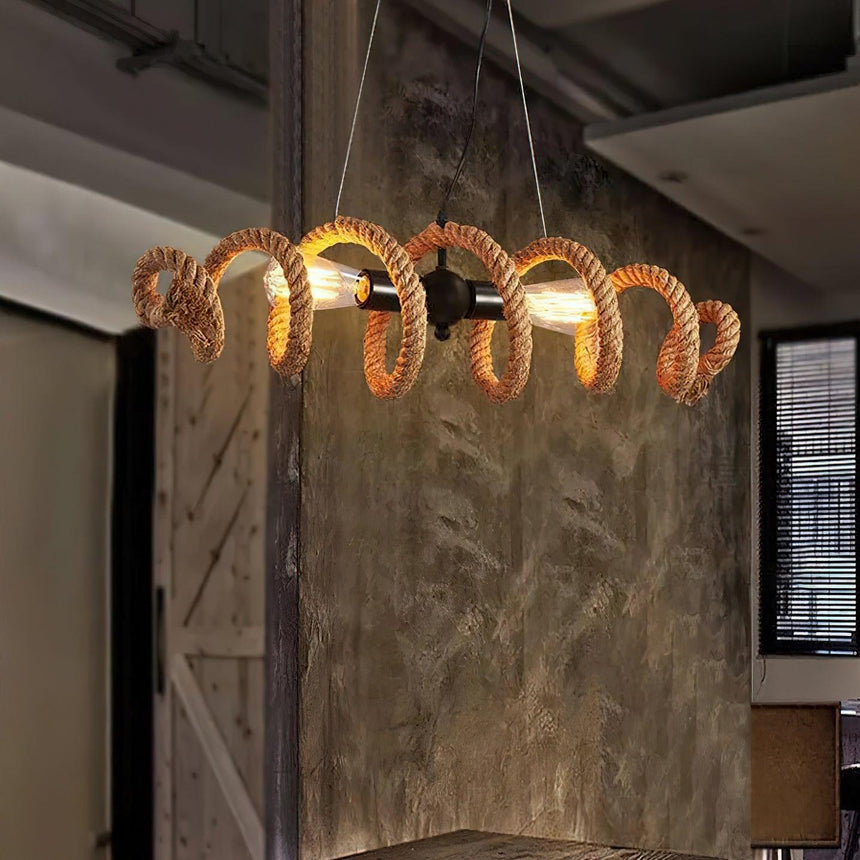 Chandelier lit against a wood plank wall above a work table