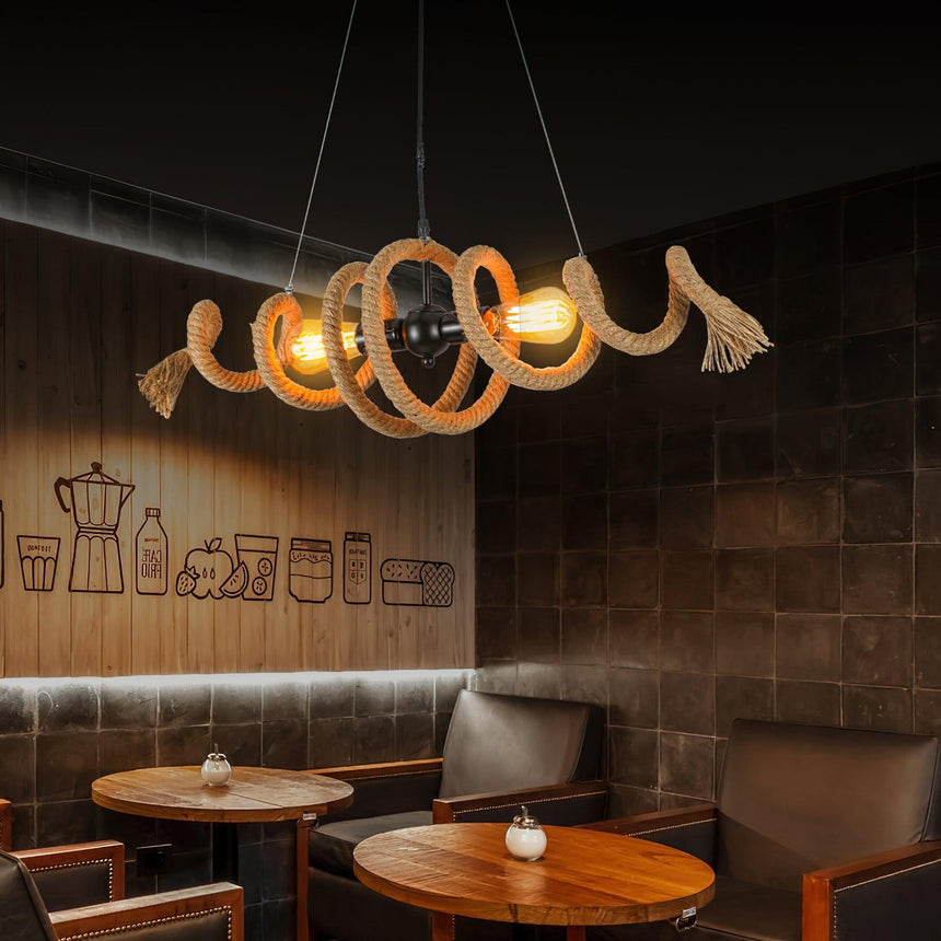 The coil lit above two round cafe tables against a dark wall