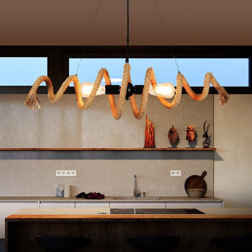 The fitting lit above a kitchen counter with jars and a window behind