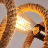 A filament lamp burning between two coils of hemp rope, seen close
