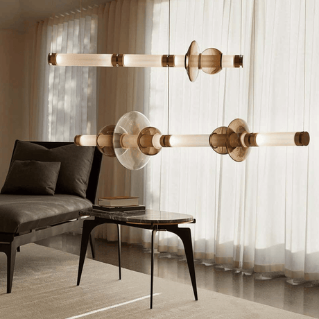The linear bar lit above a low table beside a dark armchair