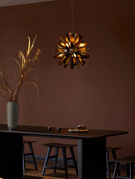 The burst lit above a dark dining table with plain wood chairs