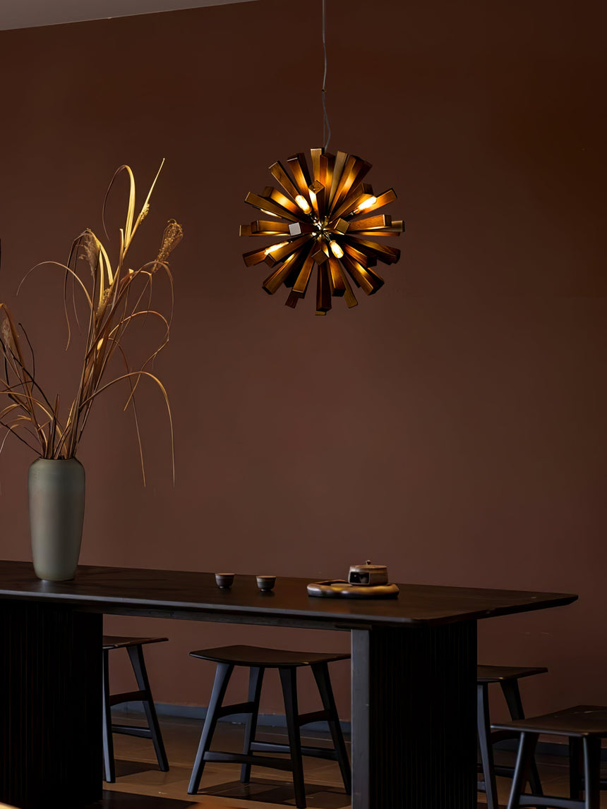 The burst lit above a dark dining table with plain wood chairs