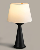 Japandi table lamp with the black hourglass base seen from the front