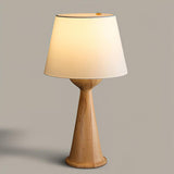 Japandi table lamp with the natural wood hourglass base, front view