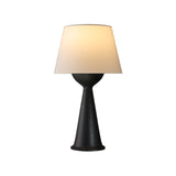 Natural wood Japandi table lamp lit and seen from the front, plain ground