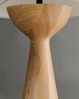 The small Japandi table lamp lit and seen against a plain ground