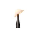Black cone table lamp with a tilted white shade against a plain ground