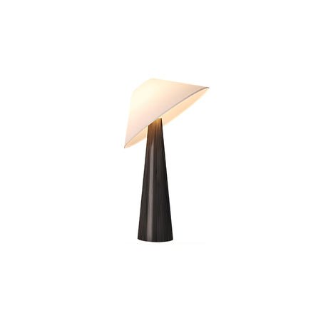 Black cone table lamp with a tilted white shade against a plain ground