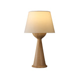 Walnut Japandi table lamp lit and seen from the front, plain background