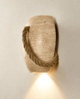 The urn with the rope running down its left side, the downlight glowing below