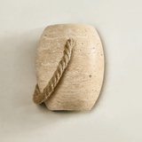 The urn seen slightly from the side, showing its rounded belly and flat top