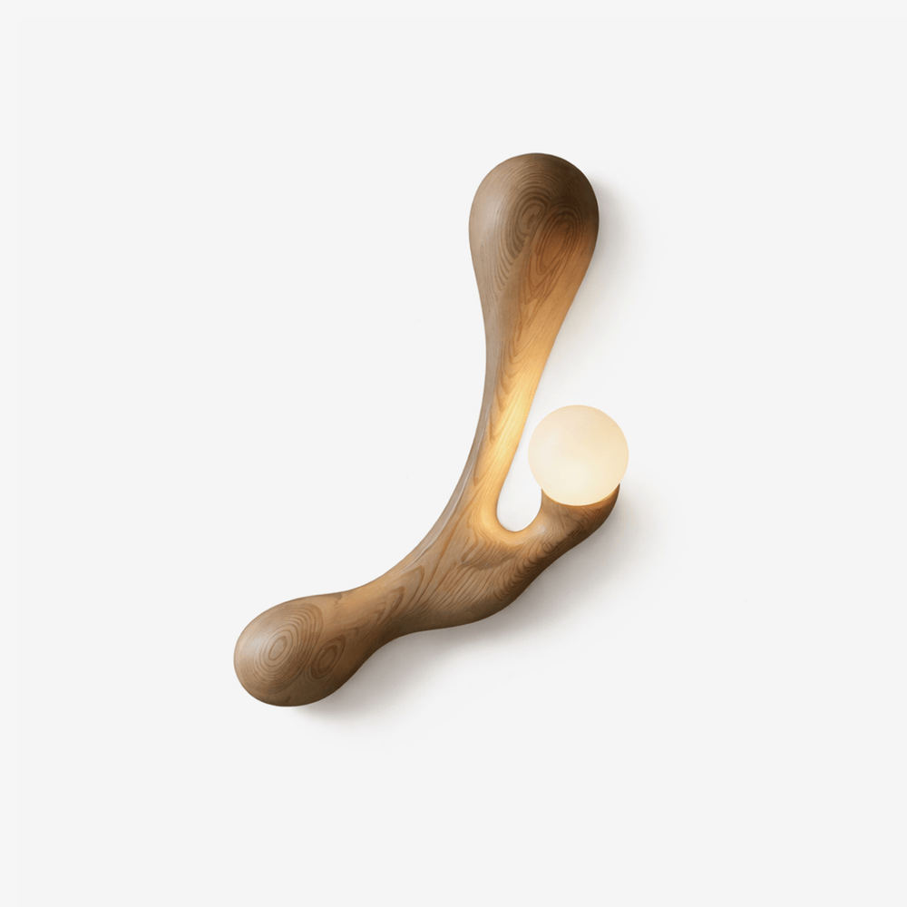 Japandi wall sconce, a carved wood arm cradling an opal glass globe