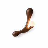 The walnut version, the grain running the length of the carved arm