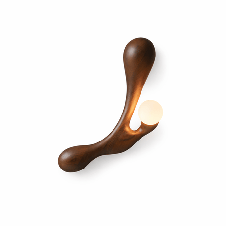 The walnut version, the grain running the length of the carved arm