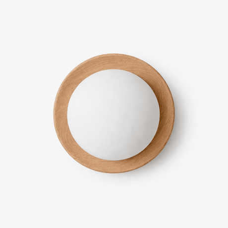 Japandi wall sconce, a pale wood ring holding a large frosted glass ball