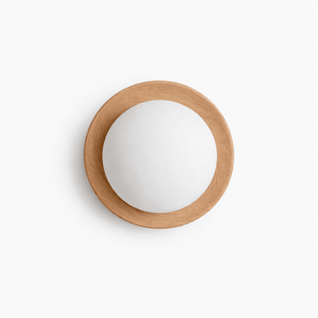 The pale wood ring lit close, the frosted ball glowing inside the frame