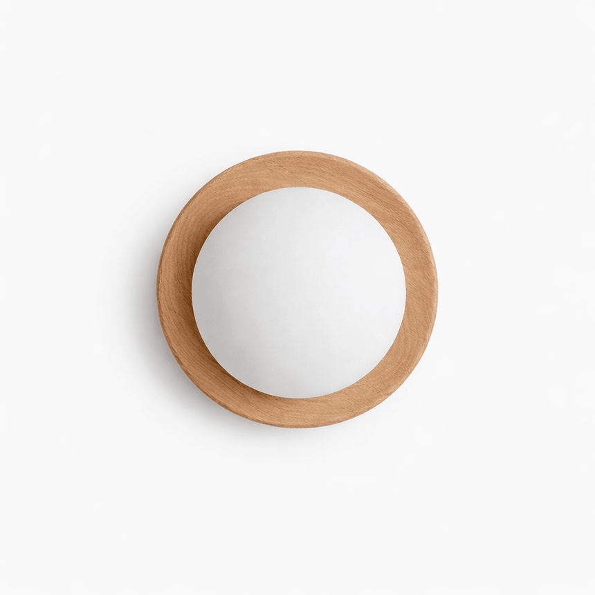 The pale wood ring lit close, the frosted ball glowing inside the frame