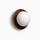 The walnut ring at an angle, the glass ball standing clear of the wood