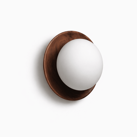 The walnut ring at an angle, the glass ball standing clear of the wood
