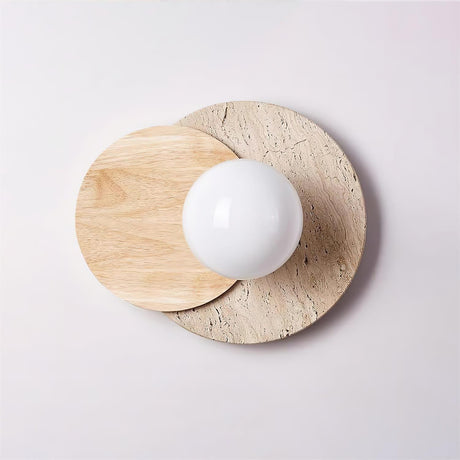 Light wood and travertine discs with an unlit white orb, seen flat