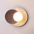 Walnut disc over a travertine disc with the white orb lit between them