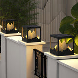 The frame lit on a white pillar beside a dark slatted garden fence